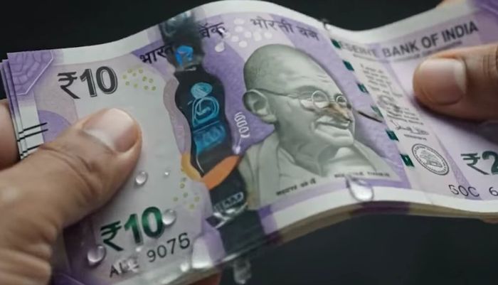 Polymer and paper Indian currency notes displayed together during the RBI trial